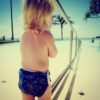 toddler at swimming pool wearing big reusable swim nappy to fit baby and kids from 8-24 kg